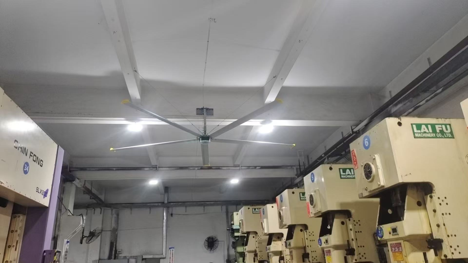 HVLS fan installed above machinery in a production workshop