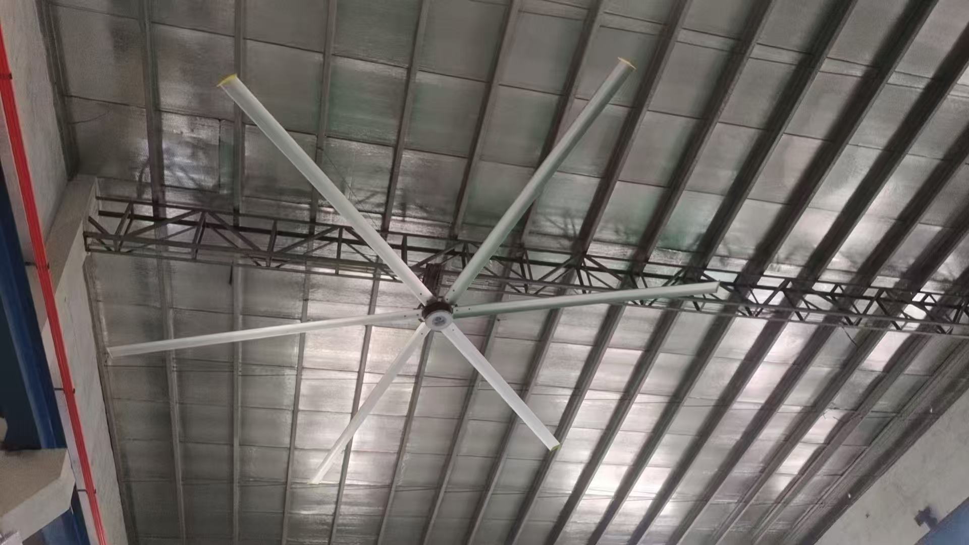 Large industrial fan installed below a steel roof