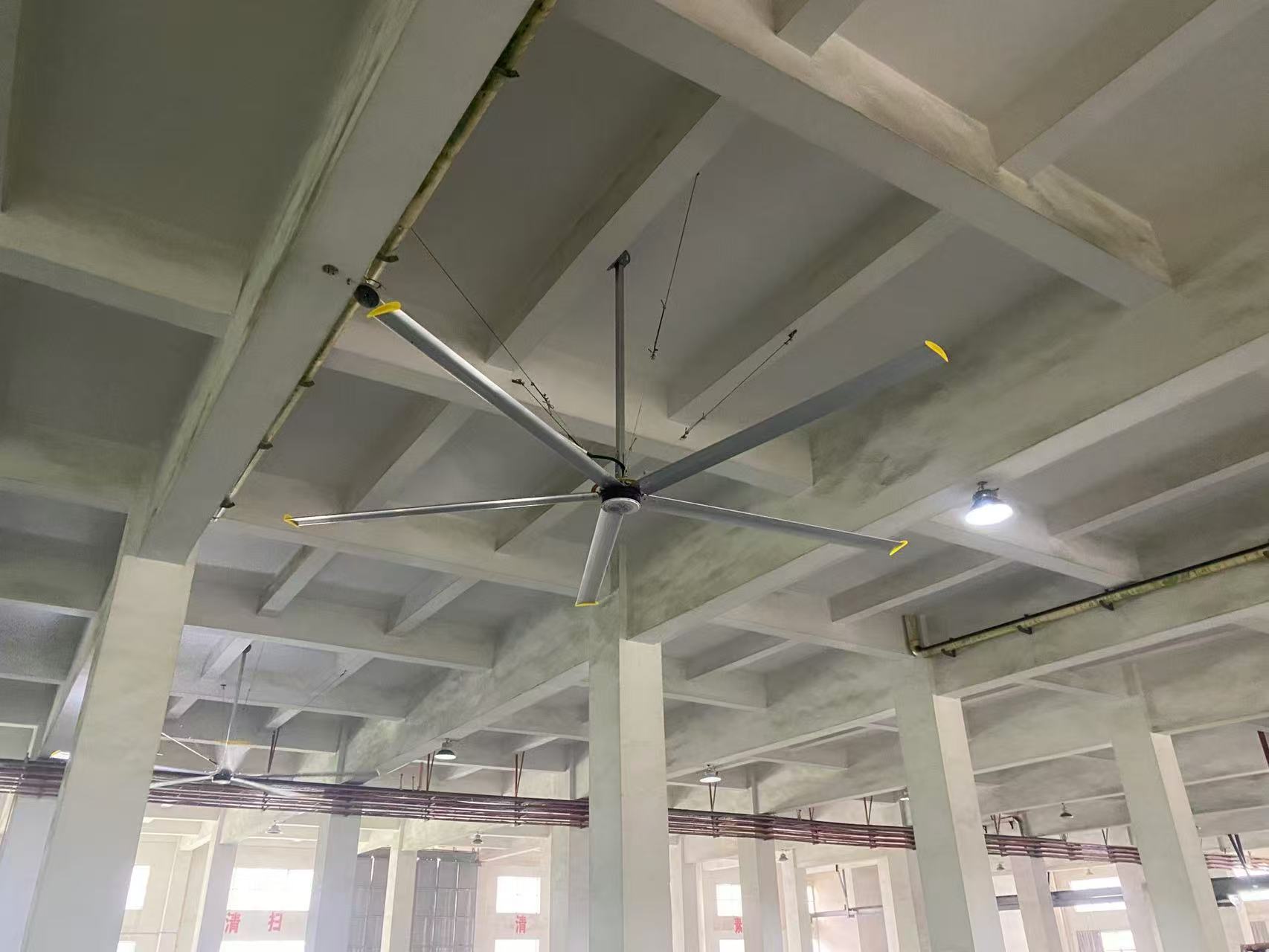 Industrial big fan installed on a workshop ceiling
